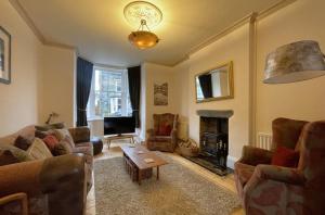 a living room with two couches and a fireplace at 45 Eskin Street in Keswick