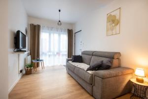 a living room with a couch and a tv at Rosamel - Studio à 1km de la gare proche port in Étaples +4 photos