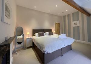 a bedroom with a large bed and a mirror at 45 Eskin Street in Keswick