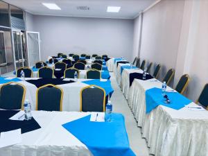 a room with blue and white tables and chairs at Dikukama Executive Hotel in Tshabong