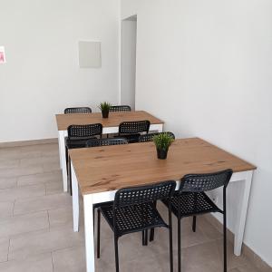 a row of tables and chairs with plants on them at Lagos Charming Villas in Lagos