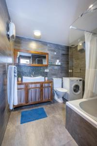 a bathroom with a sink and a washing machine at Best Location 3BR Specious Apartment By Vacay in Tel Aviv