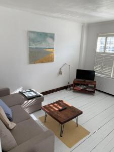 a living room with a couch and a coffee table at Charming 2-Bedroom Maisonette in Leigh-on-Sea