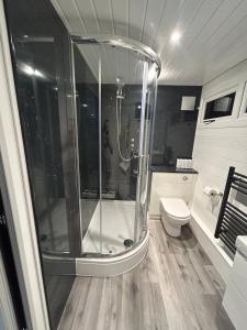 a woman taking a picture of a shower in a bathroom at Luxury and Style - The Garden Room in Winslow +14 photos