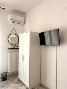 a room with a white cabinet and a mirror at La casa di Michelle in Foggia +39 photos