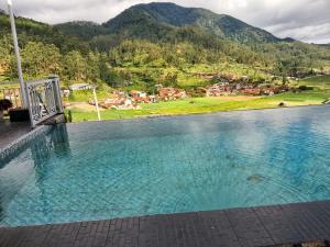 a swimming pool with a view of a mountain at BAHAR rest in Panundaan