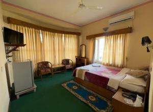 Uma cama ou camas num quarto em Green Tara Hotel