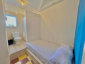 a small bathroom with a bed and a toilet at Urban Hotel in Guatemala +37 photos