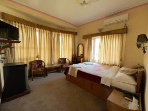 Uma cama ou camas num quarto em Green Tara Hotel