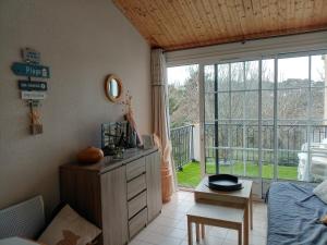 a bedroom with a bed and a large window at Studio port, lac, plage in Talmont
