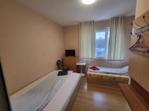 a room with two beds and a window at East Gate Guest Rooms in Plovdiv