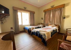 Postelja oz. postelje v sobi nastanitve Green Tara Hotel