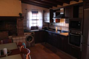 a kitchen with a washer and a dishwasher in it at Falcon Crest in Puntagorda