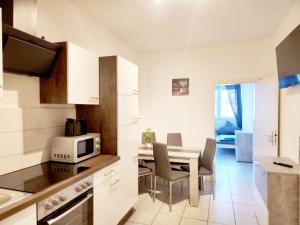 a kitchen and dining room with a table and chairs at Apartment in Herzogenrath-Merkstein in Herzogenrath