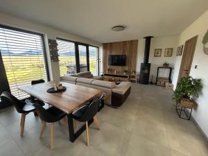 a living room with a couch and a table at Chata Balance in Žiar