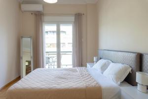 A bed or beds in a room at Cozy apartment in Pangrati area!
