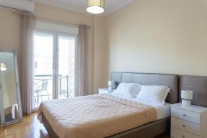A bed or beds in a room at Cozy apartment in Pangrati area!