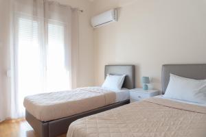 A bed or beds in a room at Cozy apartment in Pangrati area!