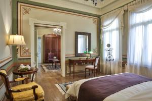 a bedroom with a bed and a desk and a table at 1905 Boutique Hotel in Xanthi