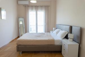 A bed or beds in a room at Cozy apartment in Pangrati area!