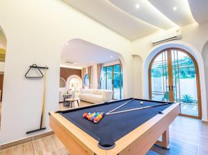 a living room with a pool table in it at So beach villa pattaya in Jomtien Beach
