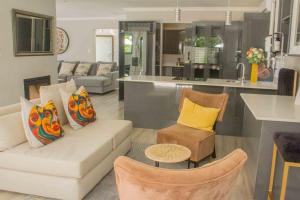 a living room with a couch and a kitchen at Serenity in Hartbeespoort