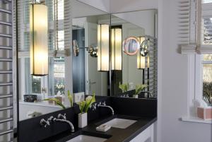 a bathroom with two sinks and a large mirror at Zollhaus 1 in Keitum +10 photos