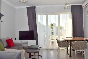 a living room with a couch and a table at Wide Beach Apartments 236 in Mullini i Danit