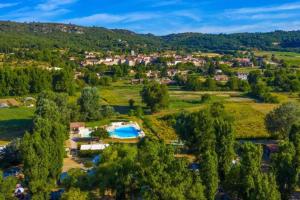 an aerial view of a small village in the hills at Camping Bel Air Village Les Prés du Verdon in Quinson