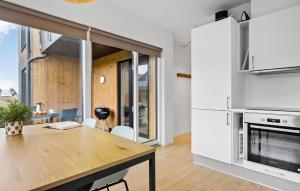 a kitchen with a wooden table in a room at Kysthusene, Lejl 19 in Slagelse