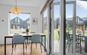 a dining room with a table and chairs at Kysthusene, Lejl 19 in Slagelse