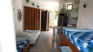 a kitchen with two beds in a room at Edificio Mar de Leva in Santa Marta