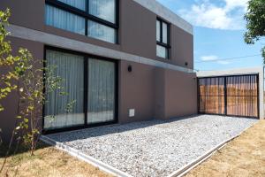 a rendering of a house with a fence at Tierra y Mar - Villas turísticas in Camet Norte