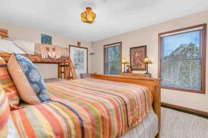 a bedroom with a bed and two windows at Panoramic View Home with Hot Tub & Game Room in Black Hawk