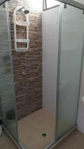 a shower with a glass door in a bathroom at Edificio Mar de Leva in Santa Marta +39 photos