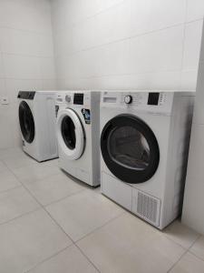 two washing machines sitting next to each other in a room at Bazan51 1 in Alicante