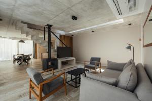 a living room with a couch and chairs and a fireplace at Tierra y Mar - Villas turísticas in Camet Norte