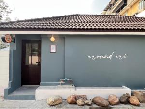 a blue building with rocks in front of it at Around Ari Hostel in Bangkok