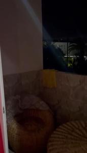 a close up of a toilet in a room with a window at plateau appartement safi in Safi