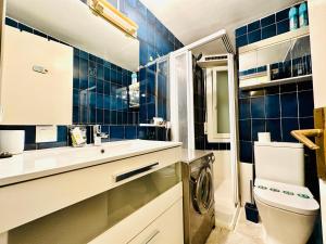 a bathroom with a sink and a washing machine in it at Global Immo 3341 Nancy in Roses +21 photos