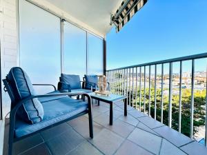 a balcony with a table and chairs and a view at Global Immo 3341 Nancy in Roses
