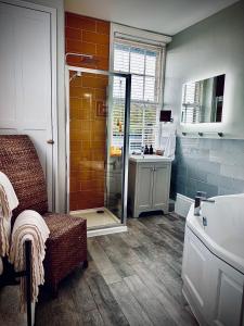a bathroom with a shower with a sink and a toilet at The Laindons in Hastings +105 photos