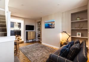 a living room with a couch and a table at 10 The Toft in Elie