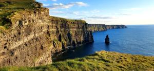 a large cliff in the ocean next to the water at Coastal Hideaway Pod in Fisherstreet