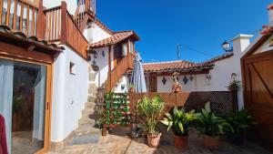 a house with potted plants in front of it at La Trinidad in La Guancha