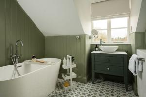 a green bathroom with a tub and a sink at Coachman's, Kailzie in Peebles +24 photos