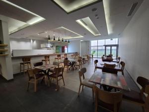 a restaurant with tables and chairs in a room at Arena Hotel Goranboy in Goranboy