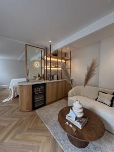 a living room with a couch and a mirror at âmé by NOAH in Cape Town +138 photos
