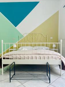 a white bed in a room with a blue ceiling at La Dolce Vita in Catania