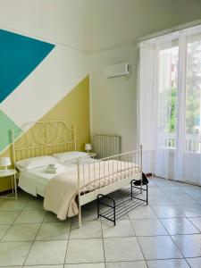 a bedroom with a bed and a large window at La Dolce Vita in Catania